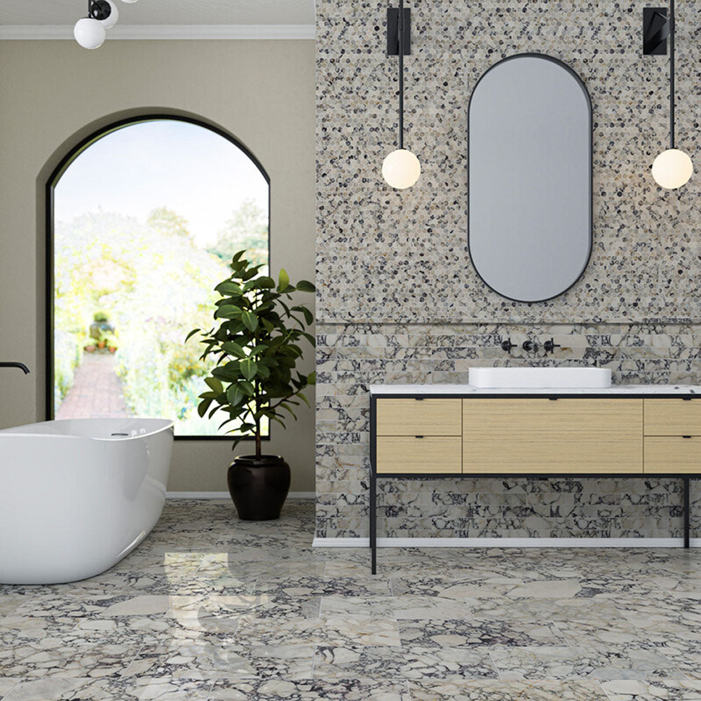Bathroom interior featuring Fayrouz Picasso natural marble tiles with a honed finish, installed across the floor and wall in a mixed format layout, showcasing a white base with bold grey, green and warm gold veining for a cohesive, statement look with rich natural variation.