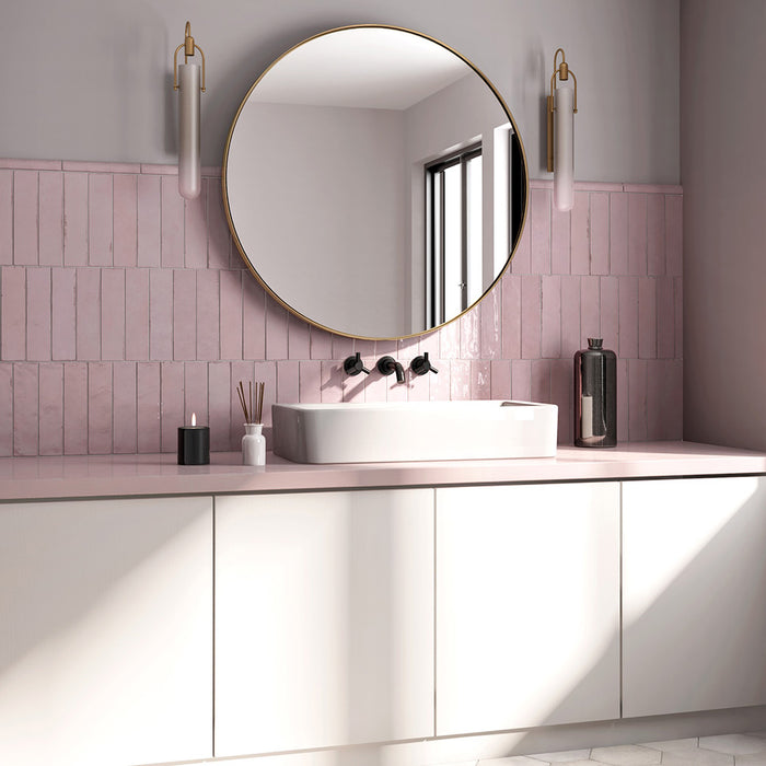 Bathroom featuring Nomad Rose brick wall tiles in a 6 × 24.6cm format, laid horizontally behind a vanity for a soft pink, industrial-style finish.
