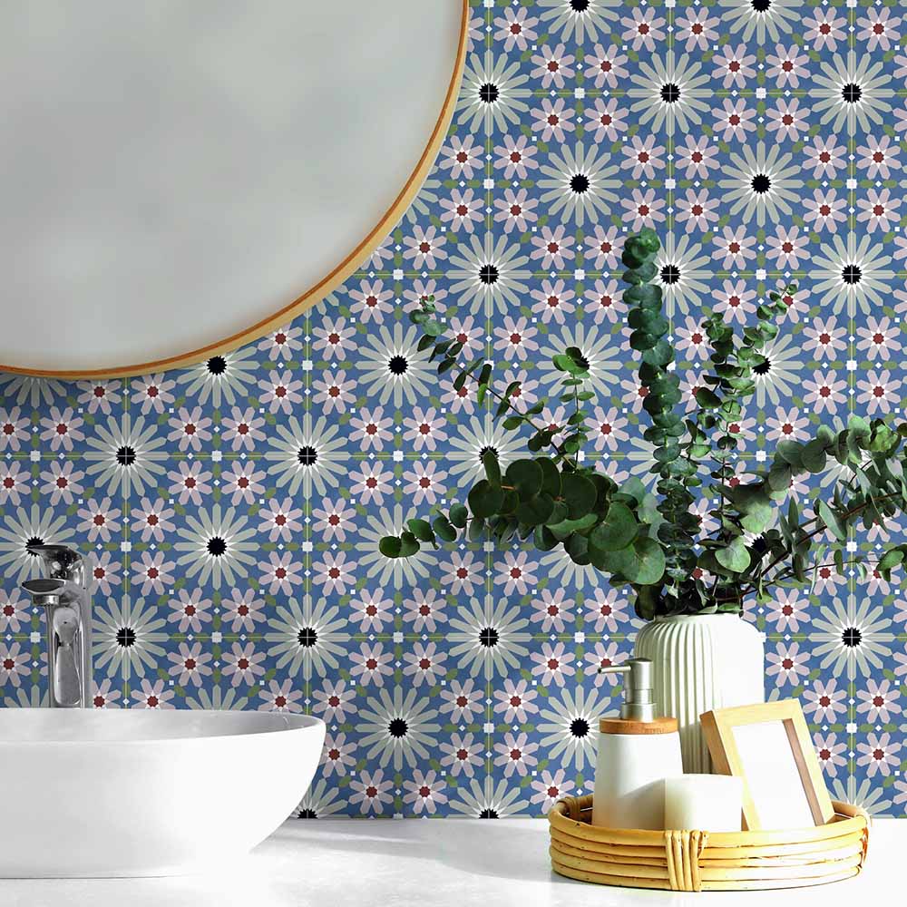 Bathroom vanity splashback featuring Fez Mini Artisan 15x15cm Moroccan-style porcelain tiles, showcasing a detailed multicolour geometric pattern in soft blue, blush pink, green and terracotta tones, styled with a round mirror, ceramic basin and natural accessories for a calm, decorative finish.
