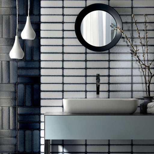 Bathroom wall featuring Alchemy Magma White 6.5×30cm ceramic wall tiles with a glossy white finish.
