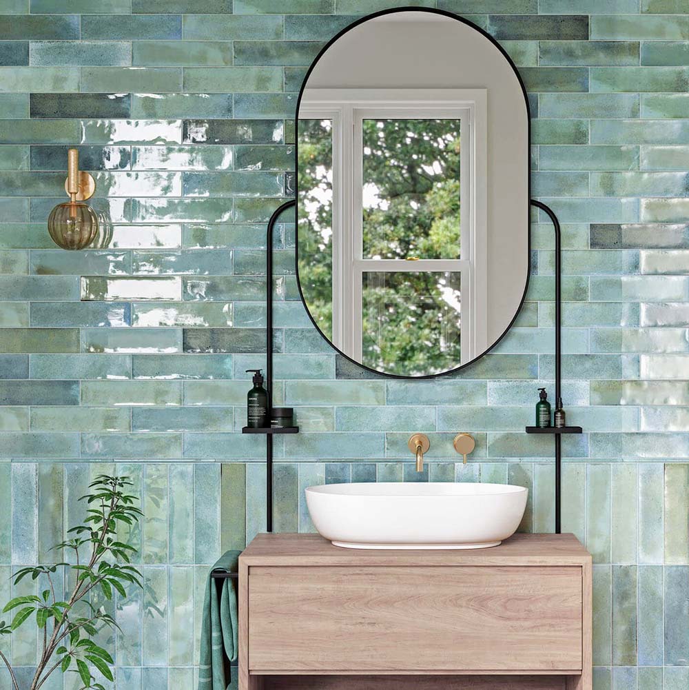 Bathroom wall featuring Allegra Celadon Green Gloss Brick ceramic tiles in a 6 × 25cm format, creating a fresh, spa-inspired look with soft green tones, a glossy finish and subtle handmade-style variation.