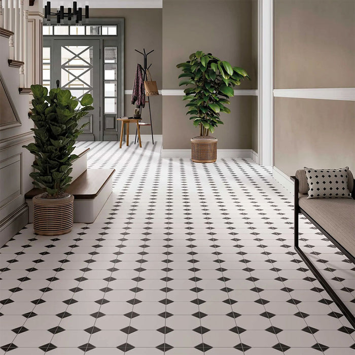 Hallway featuring Belvoir Black 33 × 33cm Victorian style porcelain floor tiles, creating a classic geometric pattern with black and white contrast. Paired with neutral walls and traditional details for a timeless, elegant finish.