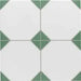 Close-up of Belvoir Green 33 × 33cm Victorian style porcelain floor tiles, showcasing a classic white base with soft green geometric detailing. Ideal for creating timeless patterned floors in hallways, kitchens, or bathrooms.