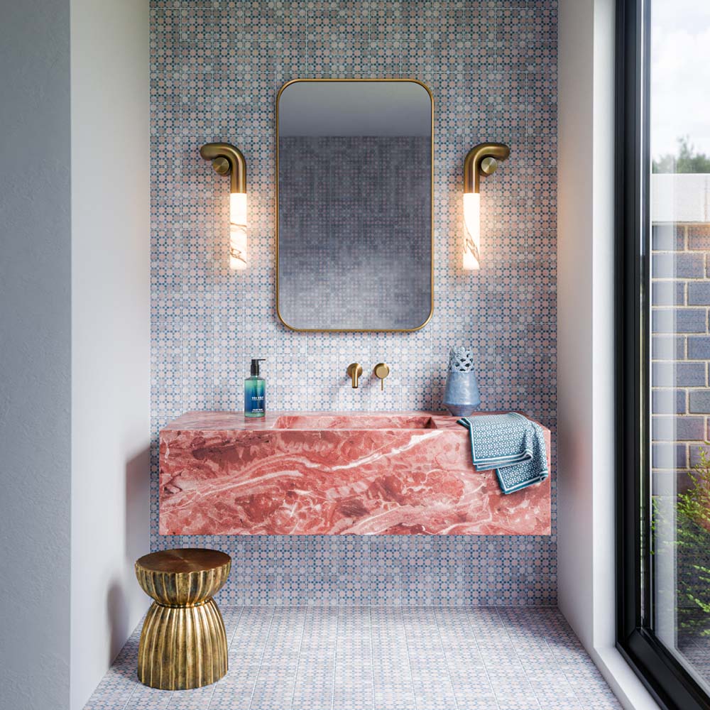 Berber Mequinez Blue 15cm x 15cm Moroccan style tiles, featuring an intricate blue and soft pink geometric pattern across the bathroom wall and floor, paired with a statement pink marble vanity and brass details.