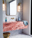 Berber Mequinez Blue 15cm x 15cm Moroccan style tiles, showcasing a delicate blue geometric pattern on a soft pink background across the bathroom wall and floor, complemented by a bold pink marble vanity and brass fittings.