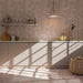 Kitchen featuring Berber Mequinez Rose 15cm x 15cm Moroccan style tiles across the walls and floor, showcasing a delicate pink geometric pattern with soft tonal variation, paired with neutral cabinetry, marble worktops and warm natural accessories.