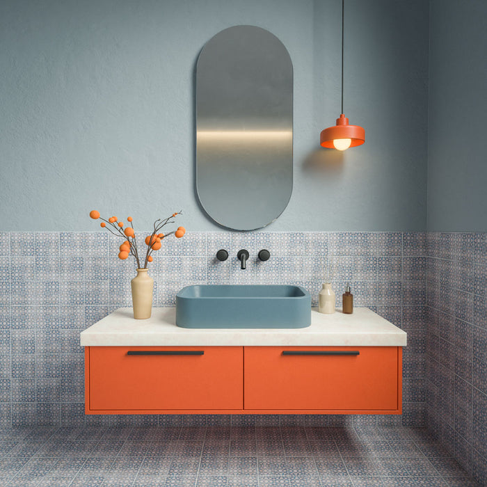 Bathroom featuring Berber Tetuan Blue 15cm x 15cm Moroccan style patterned tiles across the walls and floor, showcasing an intricate blue and white design, paired with a blue basin, orange vanity and coordinating statement lighting.