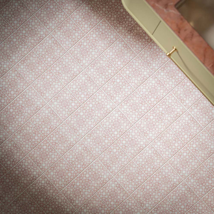 Berber Tetuan Rose 15cm x 15cm Moroccan style floor tiles, showcasing an intricate repeating geometric pattern in soft pink and white, paired with cream cabinetry and warm brass details.