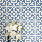 Ivy Blue Victorian Moroccan style 20x20cm patterned tiles, shown in a flat lay with decorative flowers highlighting the blue and white geometric design.