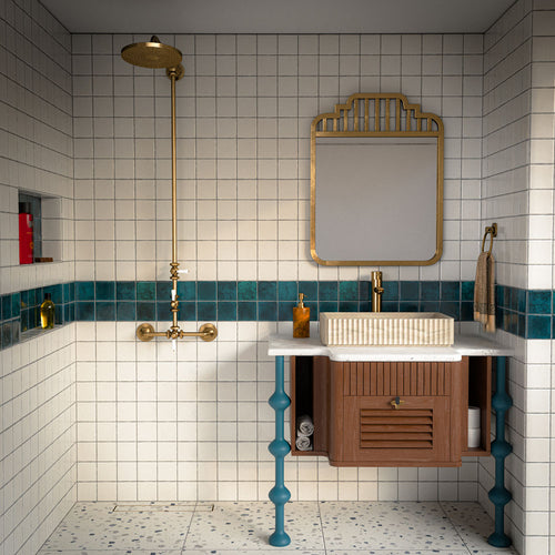 Bathroom featuring Bora Bora Amun Blue Square wall tiles in a 10cm x 10cm format with a flux glaze finish, used as a striking blue feature border alongside white wall tiles, brass fittings and terrazzo effect flooring.