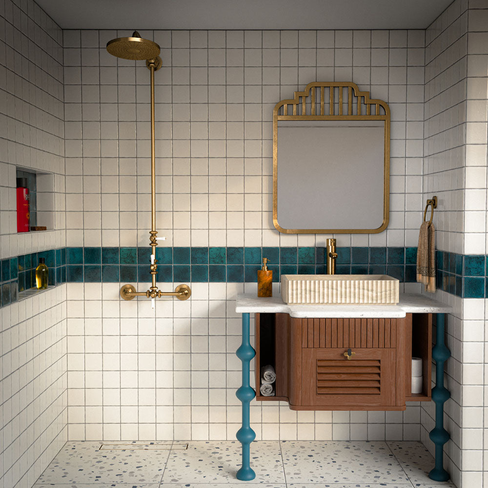 Bathroom featuring Bora Bora Amun Blue Square wall tiles in a 10cm x 10cm format with a flux glaze finish, used as a striking blue feature border alongside white wall tiles, brass fittings and terrazzo effect flooring.