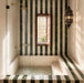Moroccan style bathroom featuring Bora Bora Green Square 10cm x 10cm wall tiles, paired with white square tiles in a striped design around a sunken bath and shower area.