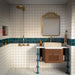 Bathroom featuring Bora Bora White Sand Square wall tiles in a 10cm x 10cm format with a flux glaze finish, paired with a teal feature border, brass shower fittings, terrazzo effect flooring and a floating timber vanity.