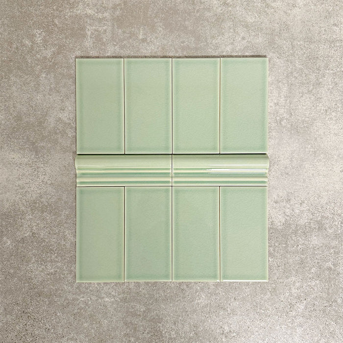 Pimlico Lime Green 7.5 × 15cm ceramic wall tiles with a crackle glaze finish, combined with matching 5 × 15cm dado trim to create a decorative horizontal feature, adding depth and classic detail to wall designs.