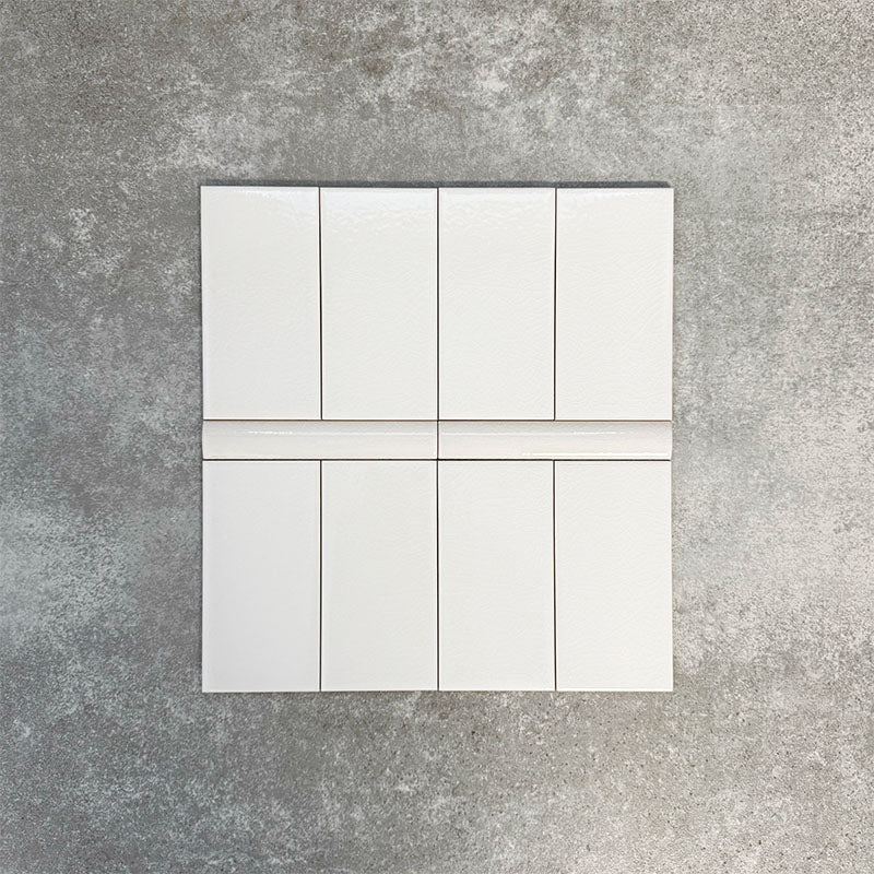 Pimlico White 7.5 × 15cm ceramic wall tiles with a crackle glaze finish, paired with matching 2.5 × 15cm pencil trim to create a classic brick layout with a subtle decorative detail.