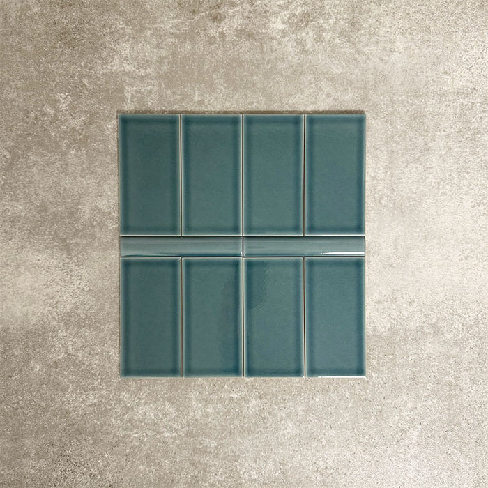 Pimlico River Blue 7.5 × 15cm ceramic wall tiles with a crackle glaze finish, paired with matching 2.5 × 15cm pencil trim to create a classic brick layout with a subtle decorative detail.