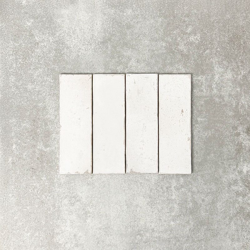 Close-up of Foundry Bricks Chalk White 6.5x20cm brick wall tiles, showcasing soft off-white tones with subtle tonal variation and lightly textured surfaces, highlighting a refined, contemporary finish with gentle edge detailing.