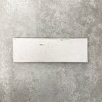 Close-up of Foundry Bricks Chalk White 6.5x20cm brick wall tile, showcasing soft off-white tones with subtle tonal variation, lightly textured surface and gently irregular edges for a refined, contemporary finish.