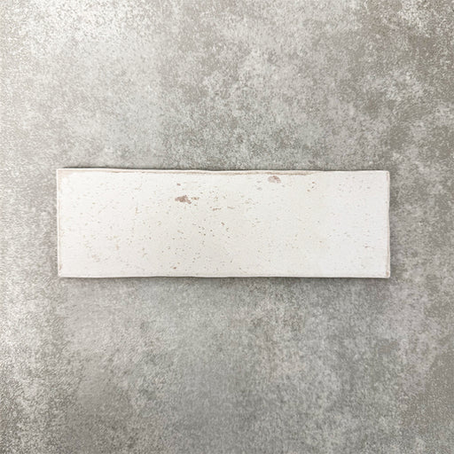 Close-up of Foundry Bricks Chalk White 6.5x20cm brick wall tile, showcasing soft off-white tones with subtle tonal variation, lightly textured surface and gently irregular edges for a refined, contemporary finish.