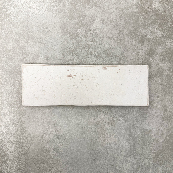 Close-up of Foundry Bricks Chalk White 6.5x20cm brick wall tile, showcasing soft off-white tones with subtle tonal variation, lightly textured surface and gently irregular edges for a refined, contemporary finish.