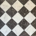 Chequerboard layout featuring Fayrouz White 15.2x15.2cm natural marble tiles with a honed finish, paired with black marble tiles, installed diagonally.