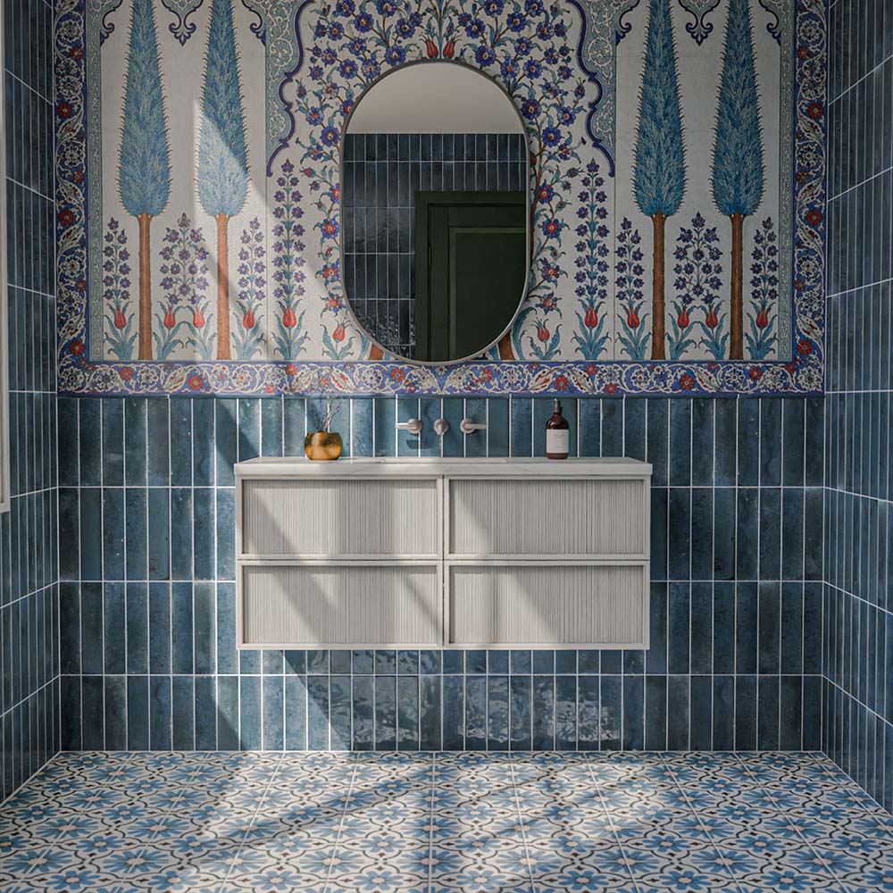 Clara Azul 20cm x 20cm Victorian and Moroccan style patterned tiles, featuring an intricate blue and white floral design across the bathroom floor, paired with rich blue gloss wall tiles and a decorative floral mural.