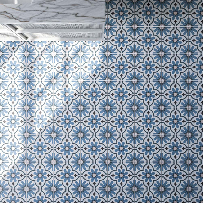 Clara Azul 20cm x 20cm Victorian and Moroccan style patterned tiles, featuring a repeating floral and geometric design in layered blue, soft grey and white tones.