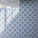 Clara Azul 20cm x 20cm Victorian and Moroccan style patterned tiles, featuring a repeating floral and geometric design in layered blue, soft grey and white tones.