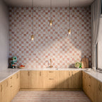 Kitchen interior featuring Amalfi patterned tiles in soft blush and ivory tones, installed as a chequerboard-effect splashback, styled with warm wood cabinetry, brass tap, pendant lighting, and natural accessories for a relaxed, contemporary space.
