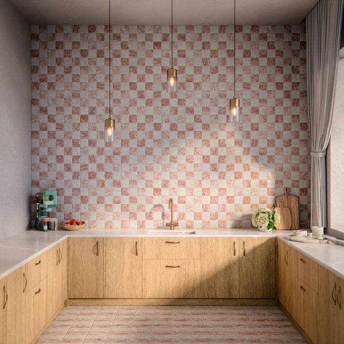 Kitchen interior featuring Amalfi patterned tiles in soft blush and ivory tones, installed as a chequerboard-effect splashback, styled with warm wood cabinetry, brass tap, pendant lighting, and natural accessories for a relaxed, contemporary space.