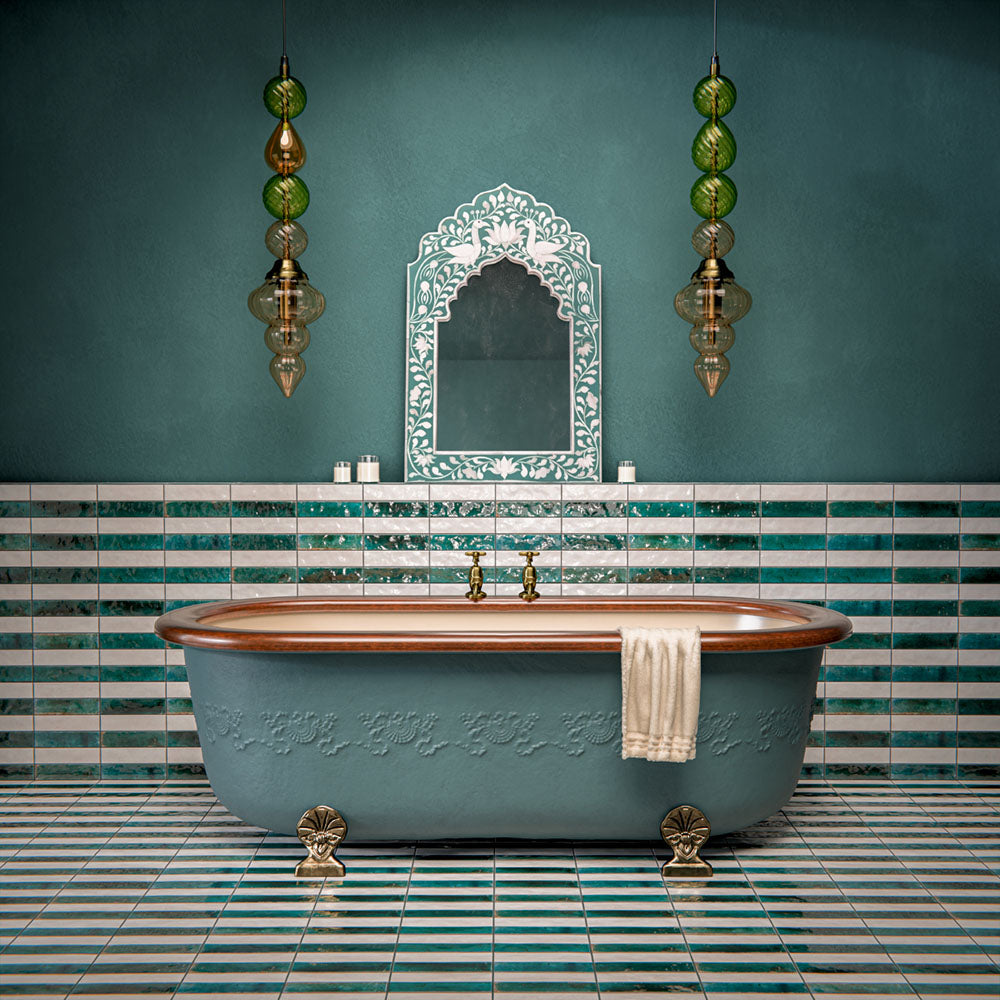 Bathroom interior featuring Levent collection tiles in green and white tones, installed in horizontal stripes across walls and floors, styled with a freestanding bath, brass fittings, and decorative lighting in a luxurious, spa-inspired setting.