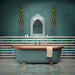 Bathroom interior featuring Levent collection tiles in green and white tones, installed in horizontal stripes across walls and floors, styled with a freestanding bath, brass fittings, and decorative lighting in a luxurious, spa-inspired setting.