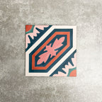 Single London Streets Conduit Street 20x20cm Victorian Moroccan style porcelain tile displayed in a product setting, featuring a bold geometric pattern in pink, teal and terracotta tones inspired by traditional decorative Victorian floor tiles.