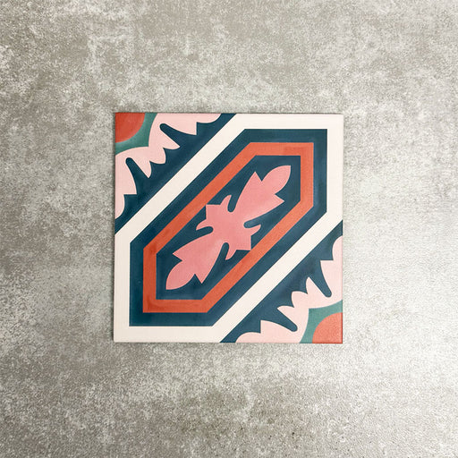 Single London Streets Conduit Street 20x20cm Victorian Moroccan style porcelain tile displayed in a product setting, featuring a bold geometric pattern in pink, teal and terracotta tones inspired by traditional decorative Victorian floor tiles.