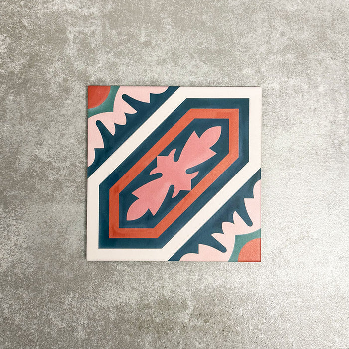 Single London Streets Conduit Street 20x20cm Victorian Moroccan style porcelain tile displayed in a product setting, featuring a bold geometric pattern in pink, teal and terracotta tones inspired by traditional decorative Victorian floor tiles.