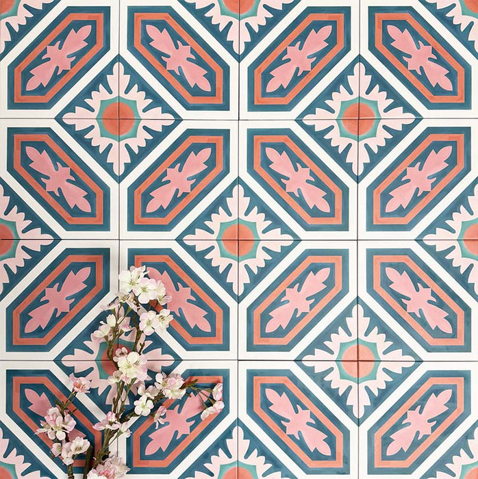 Group of London Streets Conduit Street 20x20cm Victorian Moroccan style porcelain tiles arranged to display the repeating pink, teal and terracotta geometric pattern, styled with delicate flowers in a decorative flat-lay setting.