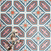 Group of London Streets Conduit Street 20x20cm Victorian Moroccan style porcelain tiles arranged to display the repeating pink, teal and terracotta geometric pattern, styled with delicate flowers in a decorative flat-lay setting.