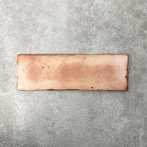 Close-up of Foundry Bricks Coral Pink 6.5x20cm brick wall tile, showcasing warm blush and terracotta tones with subtle tonal variation, lightly textured surface and gently irregular edges for a refined, contemporary finish.