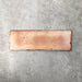 Close-up of Foundry Bricks Coral Pink 6.5x20cm brick wall tile, showcasing warm blush and terracotta tones with subtle tonal variation, lightly textured surface and gently irregular edges for a refined, contemporary finish.