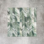 Product display of Crete Fluted Jade Matt 11.5x23cm wall tiles in green marble-effect tones, featuring fluted detailing with layered natural veining against a textured concrete-style backdrop.