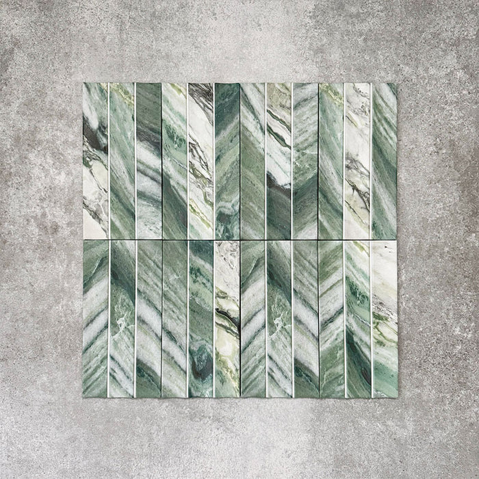 Product display of Crete Fluted Jade Matt 11.5x23cm wall tiles in green marble-effect tones, featuring fluted detailing with layered natural veining against a textured concrete-style backdrop.