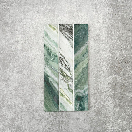 Product display of Crete Fluted Jade Matt 11.5x23cm wall tiles in green marble-effect tones, featuring fluted detailing with layered natural veining against a textured concrete-style backdrop.
