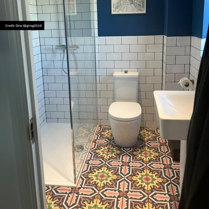 Bathroom featuring Cuba Havana 20x20cm Moroccan style patterned floor tiles, showcasing a bold geometric design in black, terracotta, sage green and cream, paired with white metro wall tiles, navy painted walls and a modern walk-in shower.