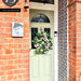 Entrance featuring Cuba Havana Mini 15x15cm Moroccan-style patterned wall tiles, styled alongside exposed brickwork and a sage green front door for a colourful, characterful exterior entrance design.