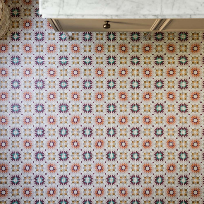 Floor featuring Cuba Manzanillo 20cm x 20cm Moroccan style patterned tiles, showcasing an intricate geometric design in pink, green, burgundy and warm neutral tones, creating a colourful statement beneath classic cabinetry.