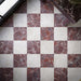 Divine Taj Mahal Matt 30cm x 30cm marble effect floor tiles, featuring a soft ivory finish paired with burgundy marble effect tiles in a classic chequerboard layout with rich natural-style veining.