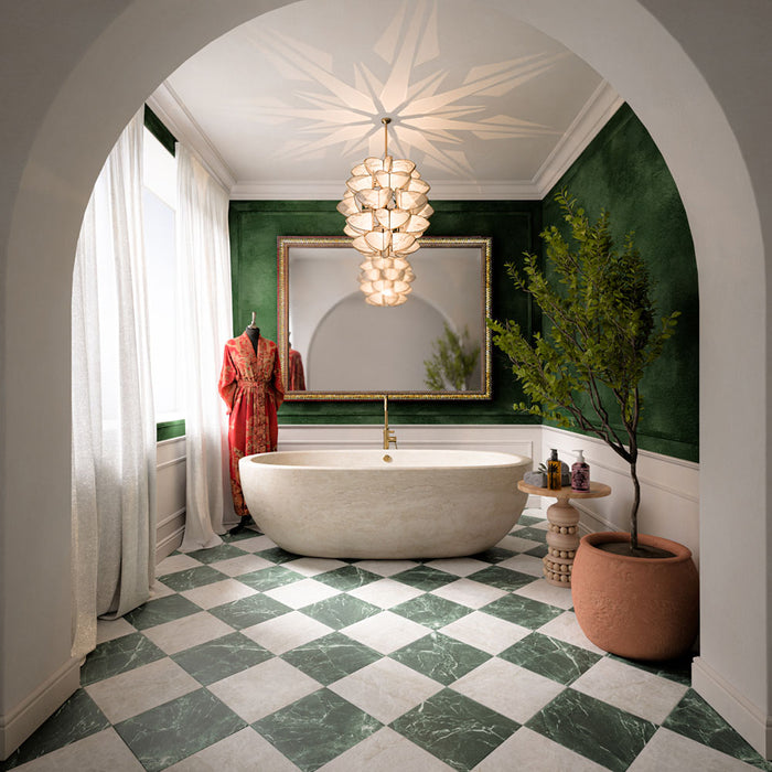 Bathroom featuring Divine Verde Green marble-effect chequerboard tiles, pairing rich green veining with soft ivory tones for a timeless floor design. Combined with deep green walls, brass accents and natural textures, the space feels elegant, luxurious and full of character.