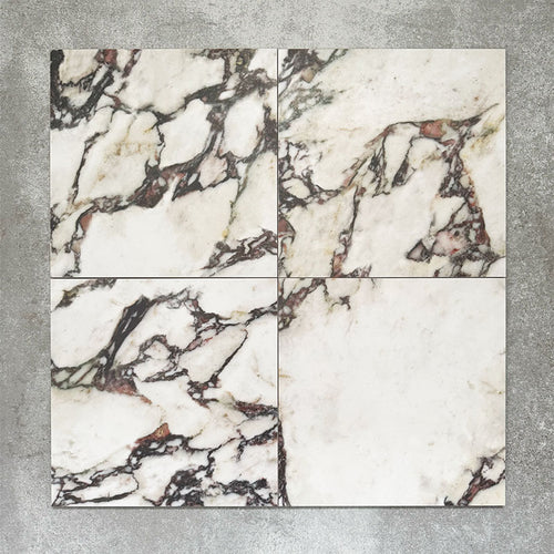 Close-up of Divine Viola matt marble-effect tile in a 30cm x 30cm format, featuring a crisp white background with dramatic burgundy, plum and charcoal veining. Inspired by luxurious natural marble, the striking contrast and rich colour variation make it ideal for statement chequerboard floors, feature areas and elegant interior schemes.