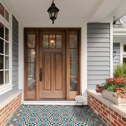 Front entrance featuring Balthazar Grand Corner 20×20cm porcelain tiles used to frame a patterned porch floor, showcasing a Moroccan-inspired geometric corner design in deep blue, warm brown and cream tones, creating a bold and cohesive statement at the doorway.