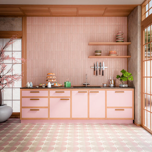 Eclipse Rosa 20cm x 20cm terrazzo effect decor tiles, featuring a soft pink and cream geometric pattern across the kitchen floor, paired with blush cabinetry, pink wall tiles and warm wood details.